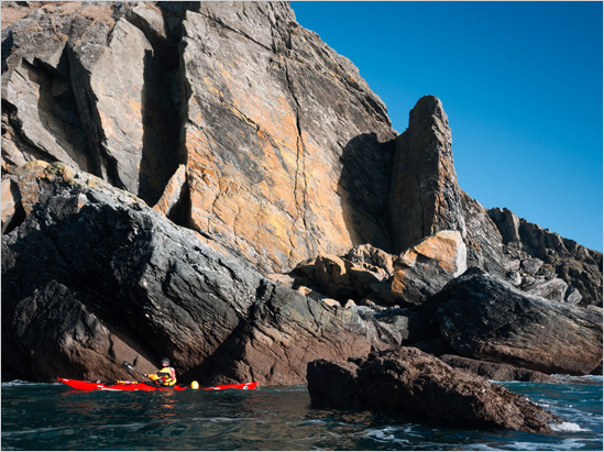 and given that I was also paddling a Romany this Tiderace Explore S was very much the odd man out.. but the all red boat looks great in pictures, especially here below the fantastic slabs of the Dodman.