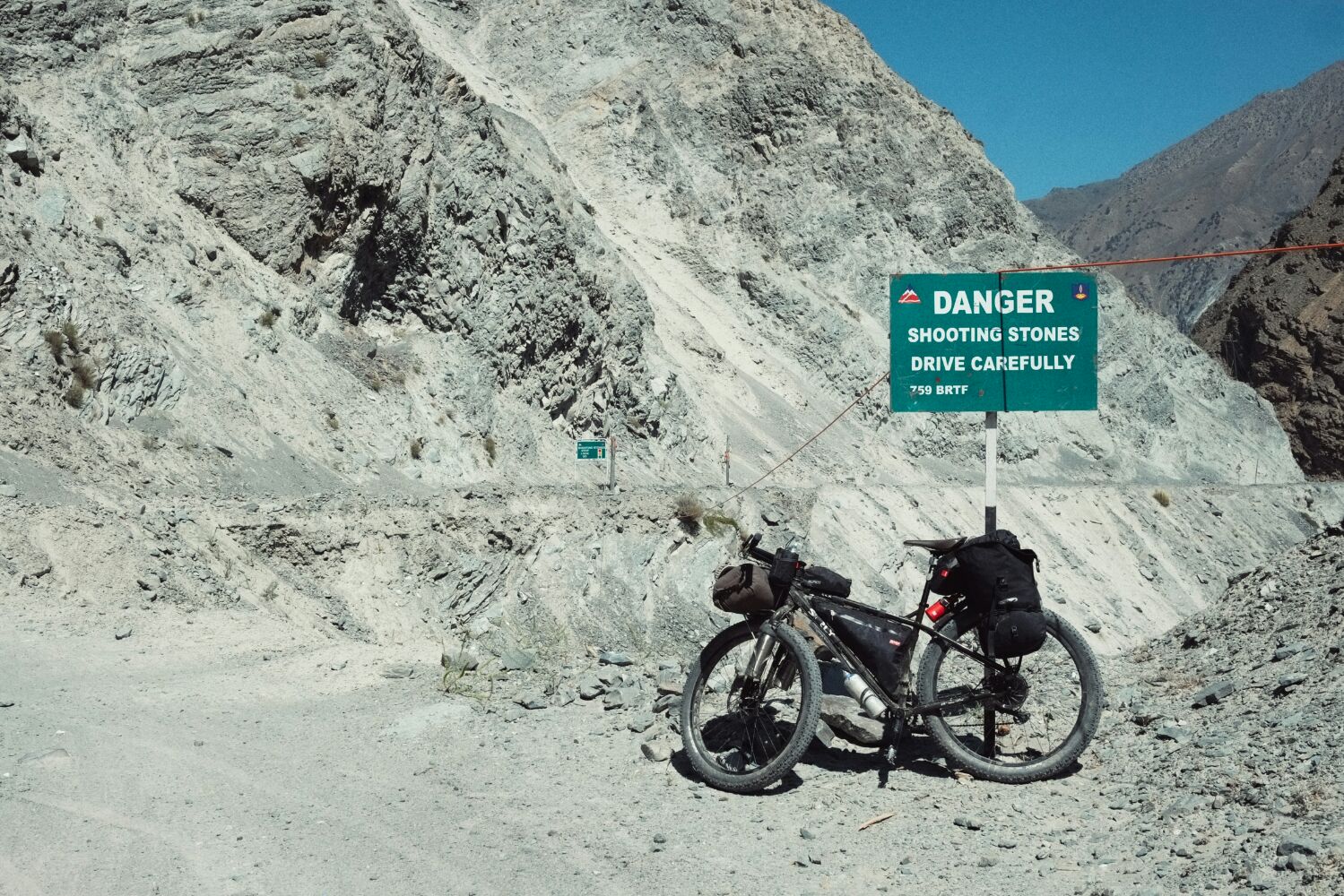 Rockfalls and landslides characterise the road. Sometimes there are warnings, other times one just has to watch out for a trickle of gravel or fresh stones lying on the road. It is a deliciously bleak road.