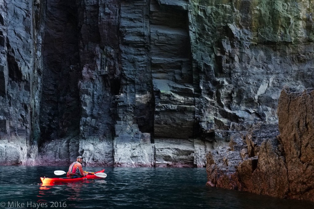 A shaft of sunlight illuminates the stern of Ben's kayak.