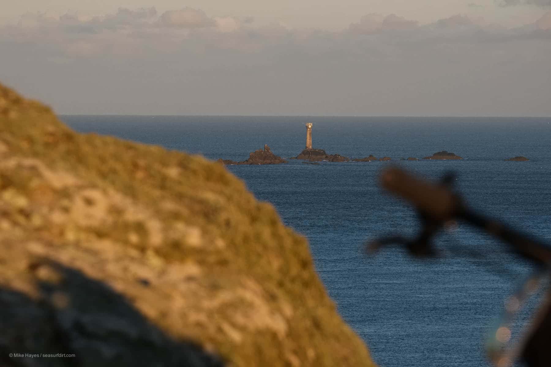 The Longships reef and lighthouse in the light of early morning