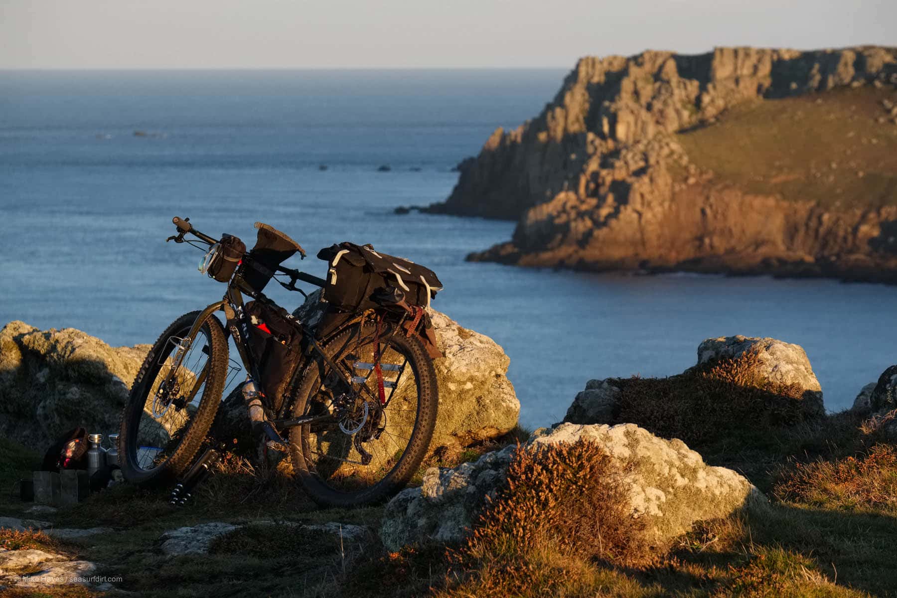 bicycle parked on the cliffs at sunrise.