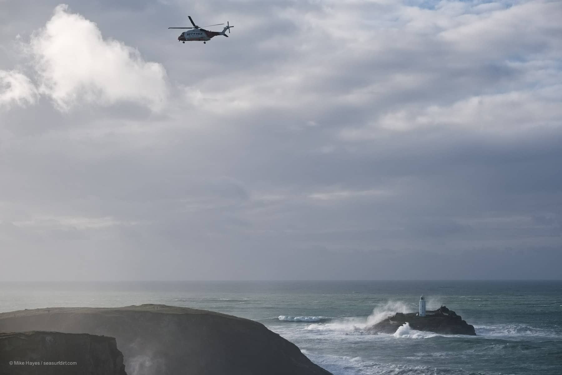 rescue helicopter with stormy weather and giant waves near Godrevy, Cornwall