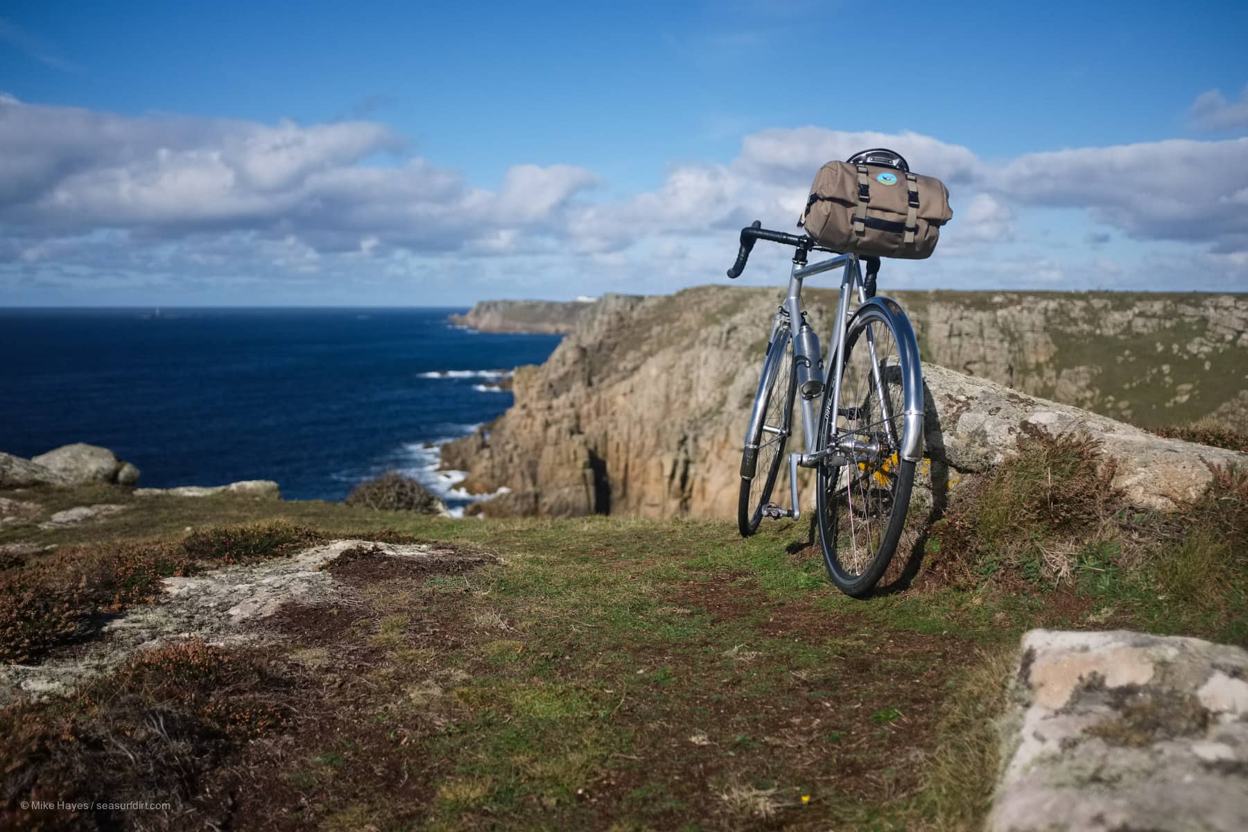 cycling in Cornwall, bicycle and a view of the coast near Lands End