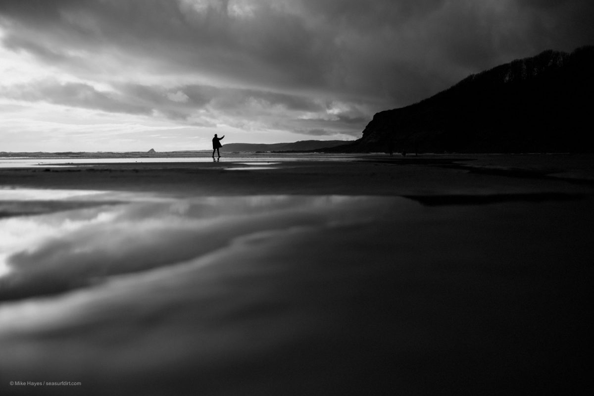 silhouette of a man taking a selfie on the beach